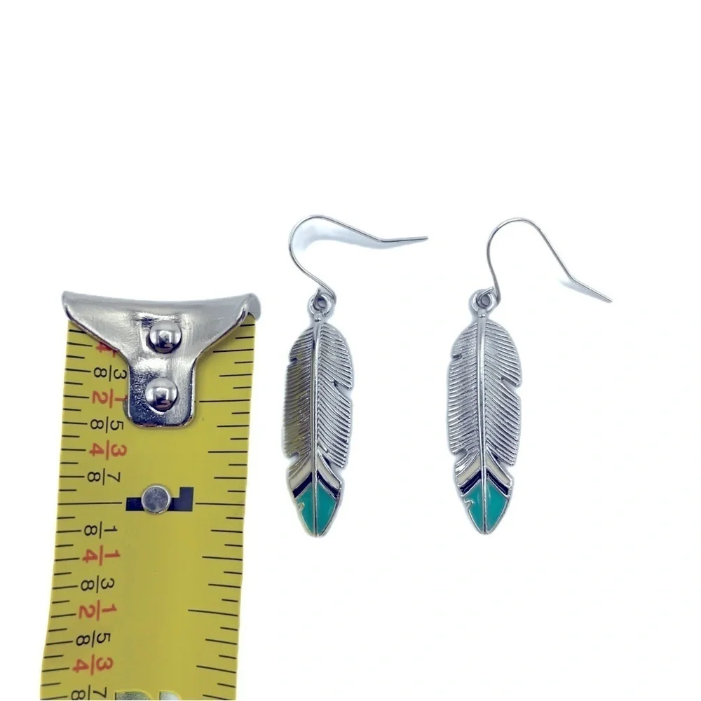Boho Festival silver tone feather earrings with turquoise blue tips